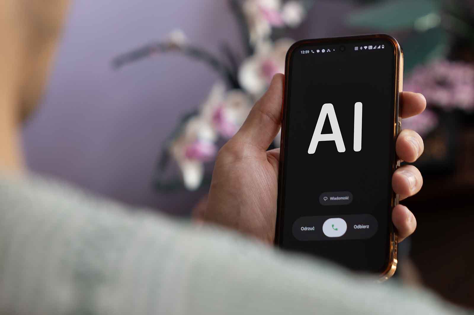 Telefon komórkowy wyświetla „AI”.